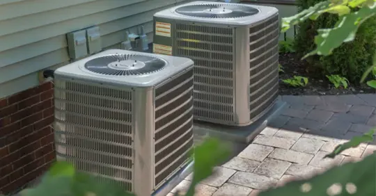 two outdoor condenser units for central AC units