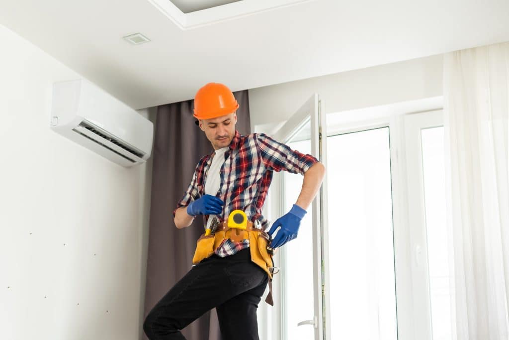 hvac technician performing emergency ac repair for tampa home in florida