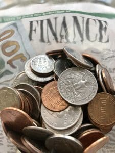 Money & Finances concept with a pile of coins on finance section of the news paper.